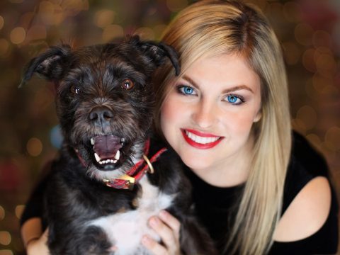 girl taking a picture with her dog that used catandogs